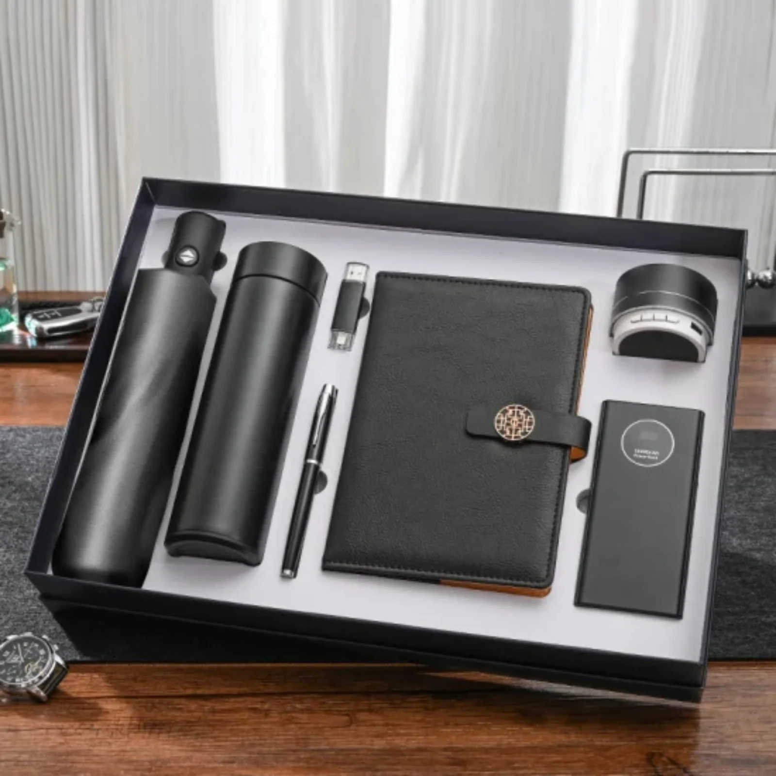 Corporate gift ideas laid out for a trade show — notebooks, drinkware, and branded items